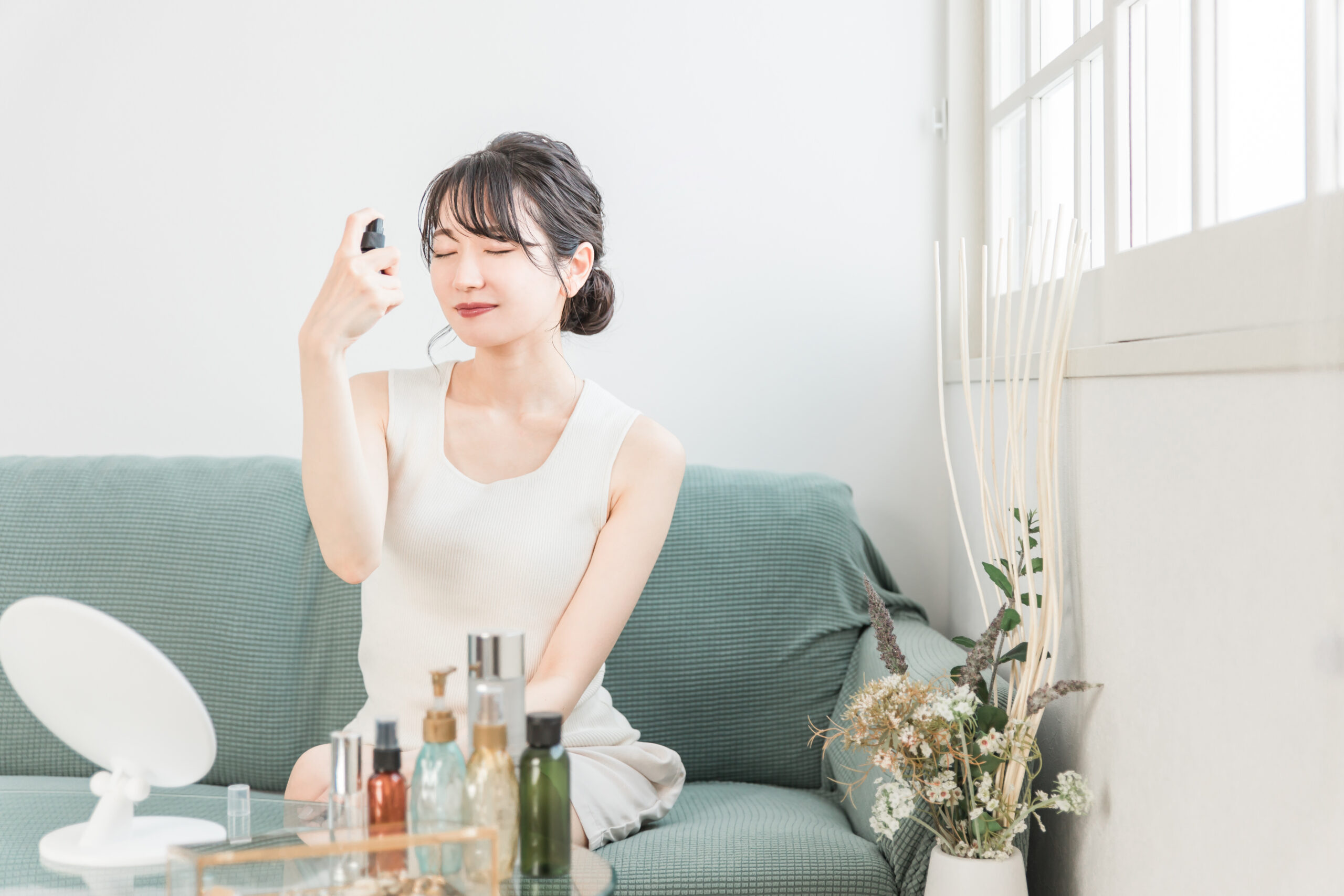 顔にスプレーする女性